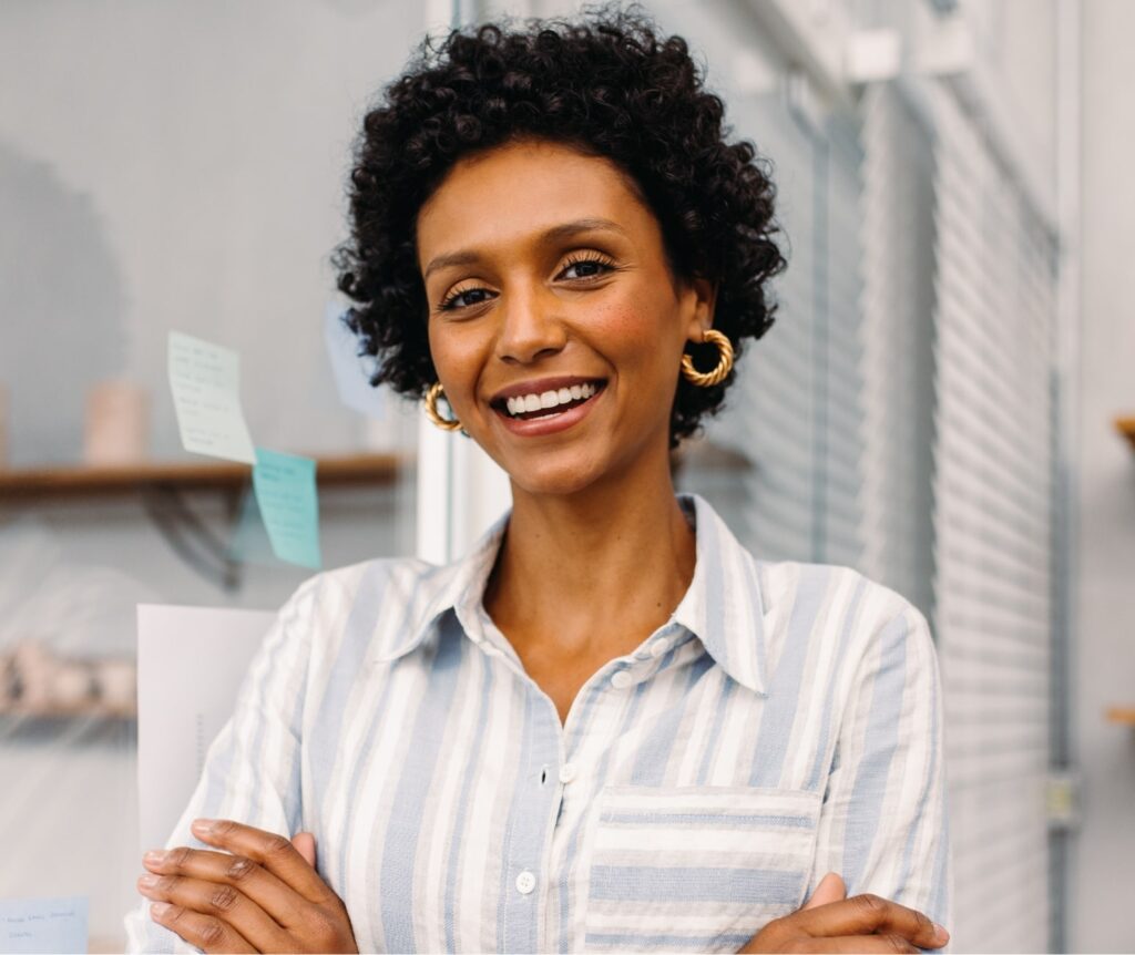 woman showing off her new smile with dentures