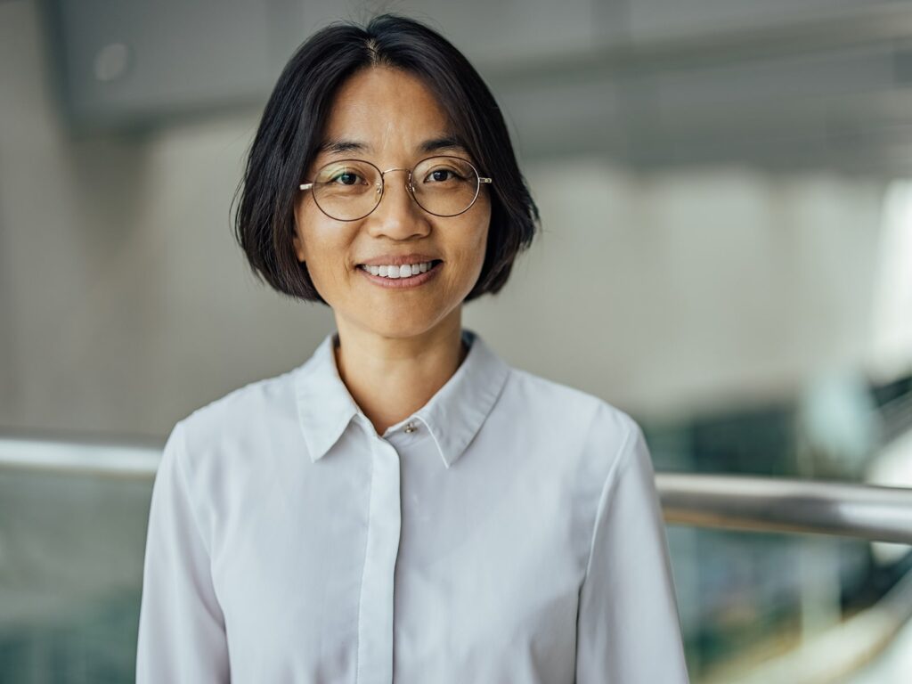 Mature woman smiling in front of a balcony